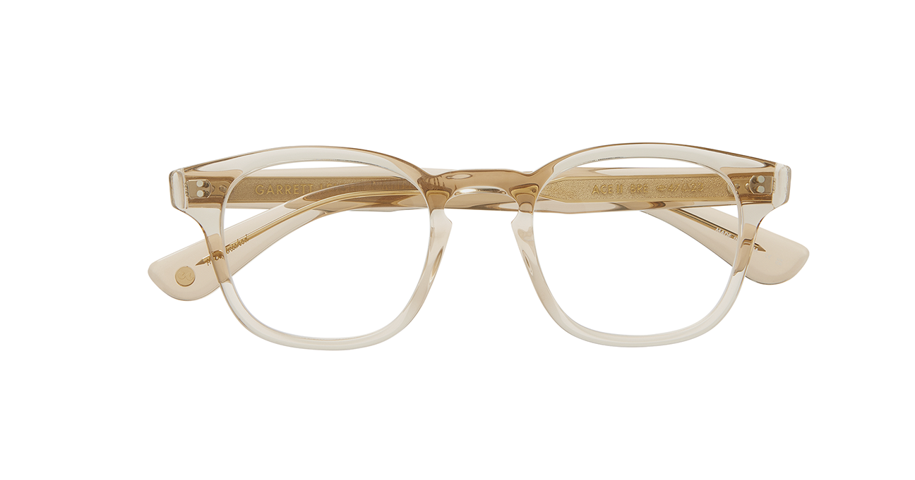 Our cult-favorite Ace Sun transformed into an optical. Ace II reflects the standard way in which we design and create premium eyewear. We’re not reinventing the wheel here – just putting some rims on ‘em. In a color we call brew, a translucent frame with a light hue of amber/brown. This image shows the frame with its arms folded.