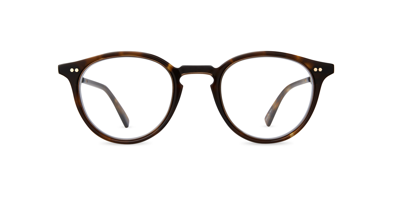 Inspired by the Golden Age of Hollywood, our classic Pantoscopic “P3” eyeglass style is updated in new colors. Exposed coil temples made from beta-titanium add strength, flexibility and fit. Accents like the titanium bridge and titanium inside eyewire provide a dash of sophistication.  Delicate filigree artwork adorns the titanium temples, which are seamlessly embedded in premium acetate.